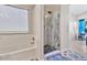 Bathroom featuring a combined tub and shower with a stylish glass shower door at 1232 W Kesler Ln, Chandler, AZ 85224