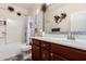 Bright bathroom featuring a vanity with decorative accents, and a shower-tub combo for a functional and stylish design at 12887 N 93Rd Dr, Peoria, AZ 85381
