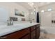 Well-lit bathroom featuring dual sinks, a large mirror, and a shower, combining style and functionality at 12887 N 93Rd Dr, Peoria, AZ 85381