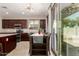 Charming dining area with dark wood cabinets, granite countertops, and lots of natural light overlooking the backyard at 12887 N 93Rd Dr, Peoria, AZ 85381