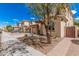 Two-story home with a landscaped front yard and a view of neighboring houses along a tree-lined street at 12887 N 93Rd Dr, Peoria, AZ 85381