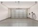 Clean, well-lit garage with epoxy flooring, offering ample space for parking and storage solutions at 12887 N 93Rd Dr, Peoria, AZ 85381