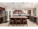 Beautiful kitchen featuring a granite island with seating, stainless steel appliances and dark wood cabinets at 12887 N 93Rd Dr, Peoria, AZ 85381