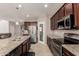 Spacious kitchen showcasing granite counters, stainless steel appliances, and a convenient pantry, blending style with functionality at 12887 N 93Rd Dr, Peoria, AZ 85381