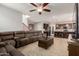 Spacious living room seamlessly transitions into a modern kitchen with tiled floors and comfortable seating at 12887 N 93Rd Dr, Peoria, AZ 85381