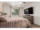 Serene main bedroom featuring a plush bed, dresser, and large window, creating a peaceful and inviting retreat at 12887 N 93Rd Dr, Peoria, AZ 85381