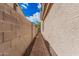 Side yard showcasing the home's brick-paved walkway and well-maintained boundary wall for added privacy at 12887 N 93Rd Dr, Peoria, AZ 85381
