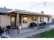 This brick-floored back patio offers comfortable outdoor seating and a view of the serene, well-maintained backyard at 13219 N 46Th Pl, Phoenix, AZ 85032
