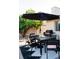 Backyard patio featuring outdoor dining set, BBQ and a lemon tree at 13219 N 46Th Pl, Phoenix, AZ 85032