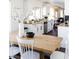 Eat-in kitchen featuring a long wooden table with white chairs and white cabinets providing ample space at 13219 N 46Th Pl, Phoenix, AZ 85032