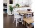 Eat-in kitchen with dining table, white chairs, and wood-look flooring at 13219 N 46Th Pl, Phoenix, AZ 85032