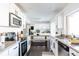 Bright eat-in kitchen featuring white cabinets, granite countertops, and stainless steel appliances for modern appeal at 13219 N 46Th Pl, Phoenix, AZ 85032