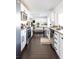 Spacious kitchen featuring stainless steel appliances, white cabinets, and tile flooring for a modern aesthetic at 13219 N 46Th Pl, Phoenix, AZ 85032