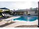Sparkling pool with diving board, sun loungers and an umbrella for relaxation and enjoyment at 13219 N 46Th Pl, Phoenix, AZ 85032