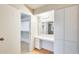 Vanity area leading into bedroom featuring ample storage and lighting at 13611 N 98Th Ave # D, Sun City, AZ 85351