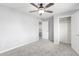 A bright bedroom has a ceiling fan and carpet flooring at 13616 N 41 Pl, Phoenix, AZ 85032