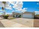 Attractive single-story home with manicured bushes, a two car garage, and a well maintained facade at 13616 N 41 Pl, Phoenix, AZ 85032