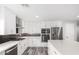 Modern kitchen with white cabinets, stainless steel appliances, and a stylish island, perfect for cooking at 13616 N 41 Pl, Phoenix, AZ 85032
