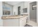 Bathroom vanity featuring granite counters, white cabinets, a large mirror, and tile backsplash at 14808 E Miramonte Way, Fountain Hills, AZ 85268