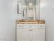 Bathroom vanity with granite countertop, white cabinets, and a mirror reflecting the room's lighting at 14808 E Miramonte Way, Fountain Hills, AZ 85268