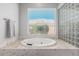 Bright bathroom featuring a soaking tub with mosaic tile surround, and a glass block window for natural light at 14808 E Miramonte Way, Fountain Hills, AZ 85268