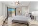 Bright bedroom with a patio door to outdoor space, a ceiling fan, and hardwood floors at 14808 E Miramonte Way, Fountain Hills, AZ 85268