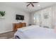 Comfortable bedroom with a TV, ceiling fan, dresser and private access to outdoor at 14808 E Miramonte Way, Fountain Hills, AZ 85268