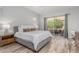 Bedroom featuring wood flooring, neutral decor, and access to a private patio, creating a peaceful retreat at 14808 E Miramonte Way, Fountain Hills, AZ 85268