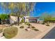 Beautiful home exterior with mature trees, desert landscaping, and a driveway at 14808 E Miramonte Way, Fountain Hills, AZ 85268