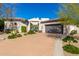Property front with desert landscaping, and a large driveway leading to the garage at 14808 E Miramonte Way, Fountain Hills, AZ 85268