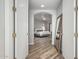 Hallway with wood flooring and an archway leading into a bedroom with plenty of natural light at 14808 E Miramonte Way, Fountain Hills, AZ 85268