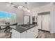 Modern kitchen features a gas cooktop island, stainless appliances, and stylish pendant lighting at 14808 E Miramonte Way, Fountain Hills, AZ 85268