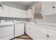 Bright laundry room with a washer, dryer, sink, and lots of cabinet space at 14808 E Miramonte Way, Fountain Hills, AZ 85268