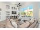 Modern living room with large windows, built-in shelving, and comfortable sectional sofa at 14808 E Miramonte Way, Fountain Hills, AZ 85268