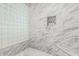 Bright shower featuring marble tile, a glass block window, and a built-in niche at 14808 E Miramonte Way, Fountain Hills, AZ 85268