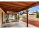 A covered patio in the backyard offers space for outdoor relaxation, enhanced by desert landscaping at 1531 E El Parque Dr, Tempe, AZ 85282