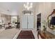 Inviting foyer featuring double doors, a chandelier, tile flooring, and an elegant area rug at 15481 W Amelia Dr, Goodyear, AZ 85395