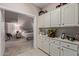 Hallway that provides a glimpse into the main bedroom, alongside built-in cabinets for storage at 15481 W Amelia Dr, Goodyear, AZ 85395