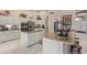 Bright kitchen featuring stainless steel appliances, granite countertops, and ample cabinet space at 15481 W Amelia Dr, Goodyear, AZ 85395