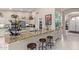 Modern kitchen with granite countertops, stainless steel appliances, and barstool seating at 15481 W Amelia Dr, Goodyear, AZ 85395
