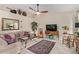 Comfortable living room featuring a ceiling fan, stylish decor, and a cozy seating area at 15481 W Amelia Dr, Goodyear, AZ 85395