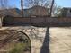 Wide backyard featuring concrete flooring with a dirt patch and a brick fence at 16317 N 152 Ave, Surprise, AZ 85374