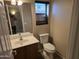 Cozy bathroom featuring a modern toilet and sink with a vanity mirror at 16317 N 152 Ave, Surprise, AZ 85374