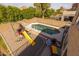 Aerial view of the backyard featuring a pool, playset, lush landscaping, and privacy fence at 1648 S Faith --, Mesa, AZ 85209