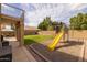 Spacious backyard features green lawn and playground with a slide and swings at 1648 S Faith --, Mesa, AZ 85209