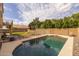 Private backyard featuring a refreshing pool, playground, lush lawn, and mature trees, perfect for Gathering enjoyment at 1648 S Faith --, Mesa, AZ 85209