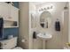 Bathroom with a pedestal sink, overhead lighting, and blue accent wall at 1648 S Faith --, Mesa, AZ 85209