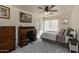 Comfortable bedroom with a ceiling fan, carpeted floors, and natural light at 1648 S Faith --, Mesa, AZ 85209