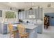 Functional kitchen featuring light-colored cabinets, an island with seating, and a seamless transition to the adjacent dining area at 1648 S Faith --, Mesa, AZ 85209