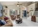Spacious living area featuring white tile flooring, large bright windows, and a staircase leading to the upper level at 1648 S Faith --, Mesa, AZ 85209
